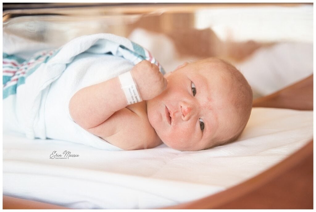 newborn baby laying awake in a hospital bassinette during fresh 48 photo session