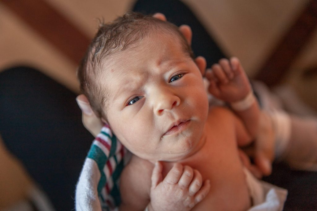 newborn baby looking at camera in hospital